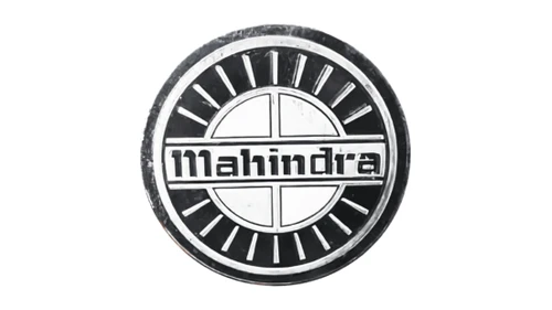 Old Mahindra medallion badge: black ring, silver rim and the Mahindra name on a banner across the middle